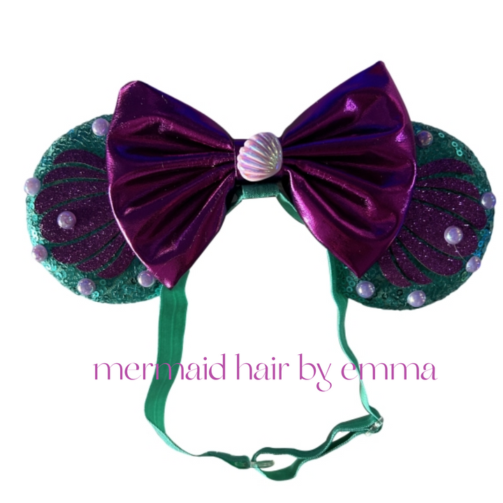 A child wearing a Disney-themed pink tutu and a headband with a bow.