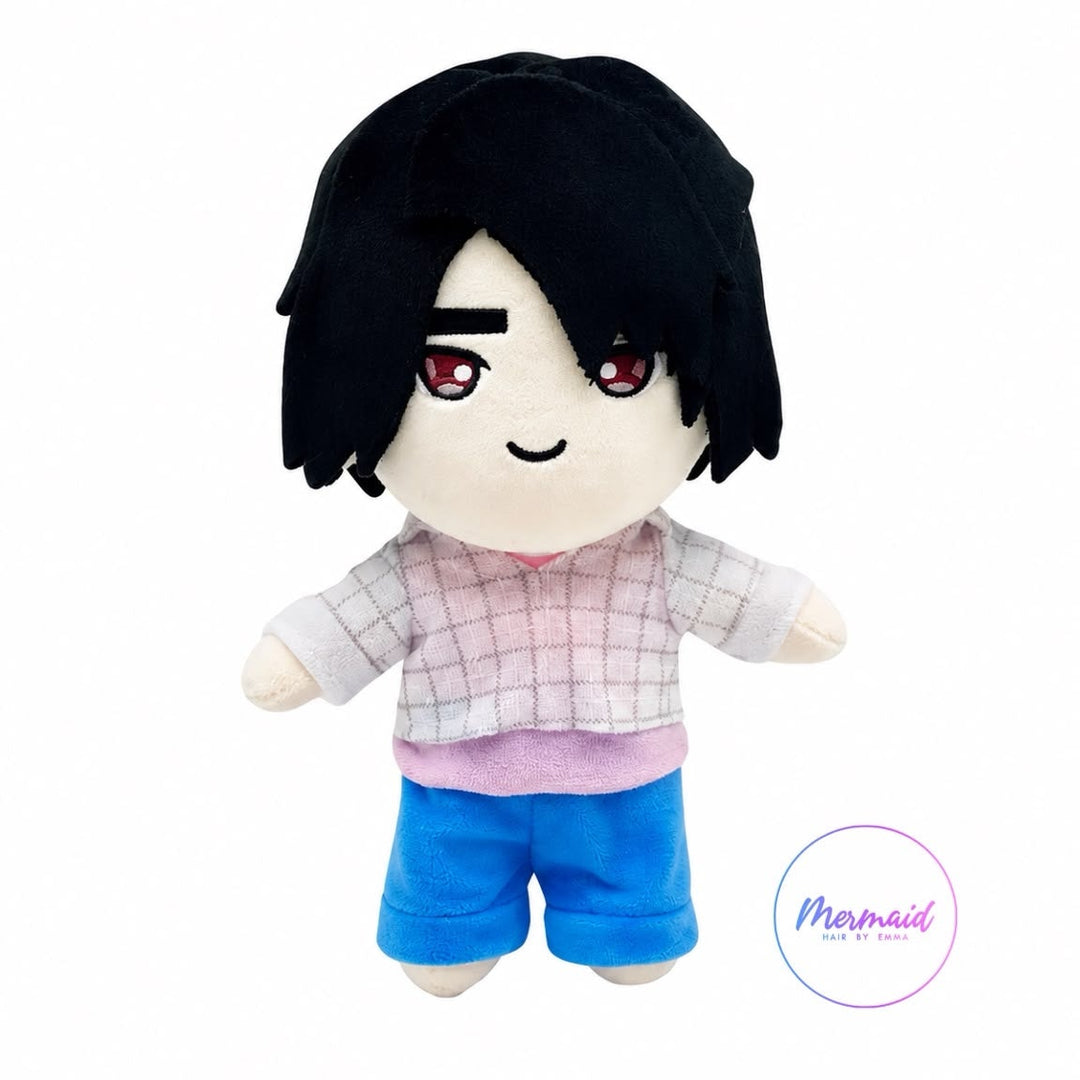 A chibi-style plush doll with black hair, a pink and white plaid shirt, and blue shorts, shown against a plain white background with a small 'Mermaid' logo in the lower right.