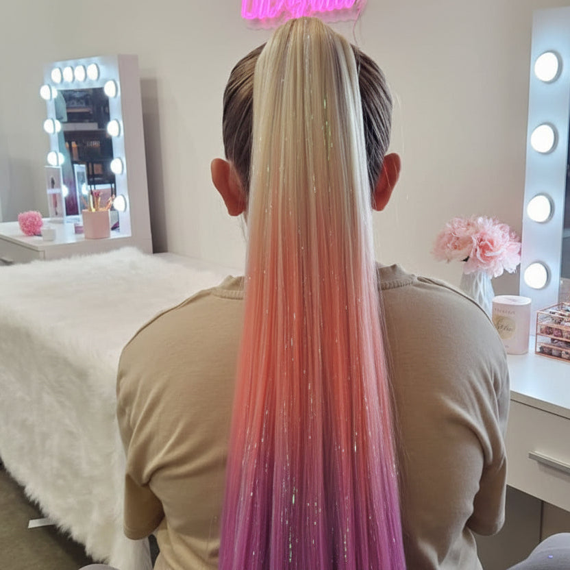 Person with a colorful hair extension in a salon setting with 'Diamond Hair & Beauty' sign.