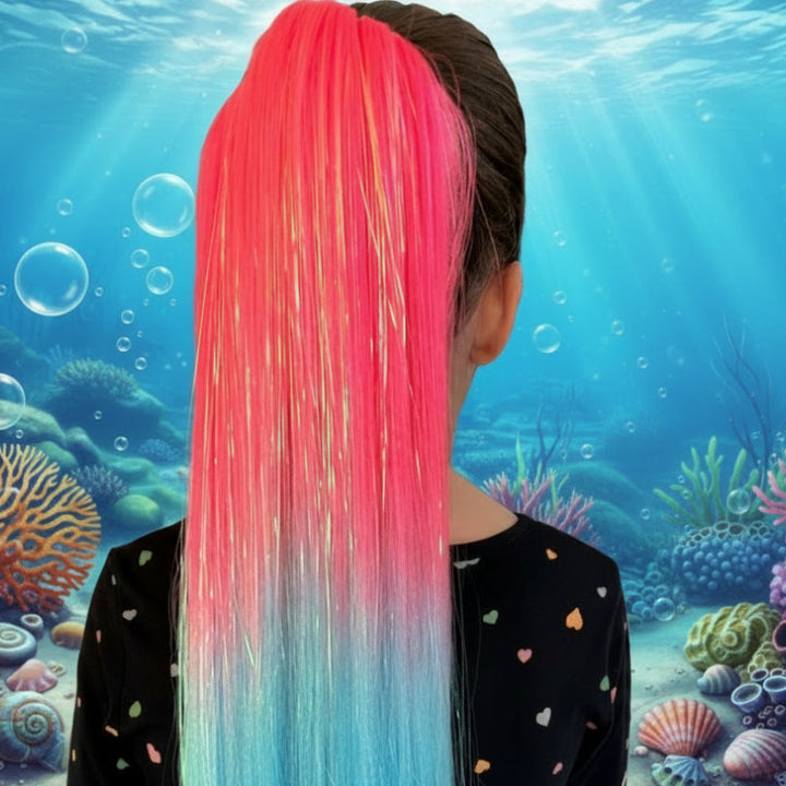 Person with a colorful ombre hair extension sitting at a table.