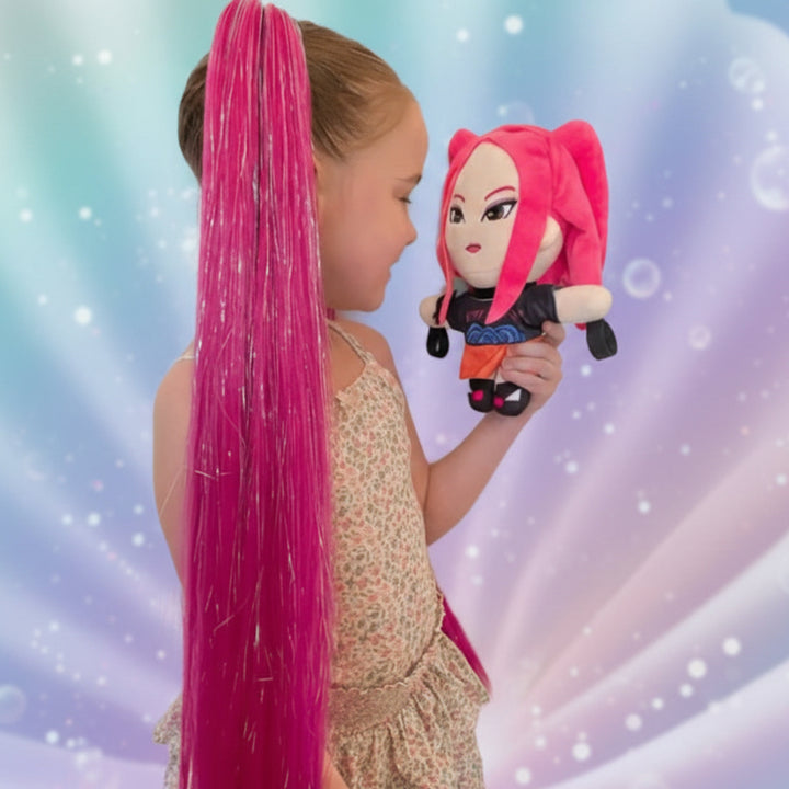 Child with long pink hair holding a plush toy against a colorful background