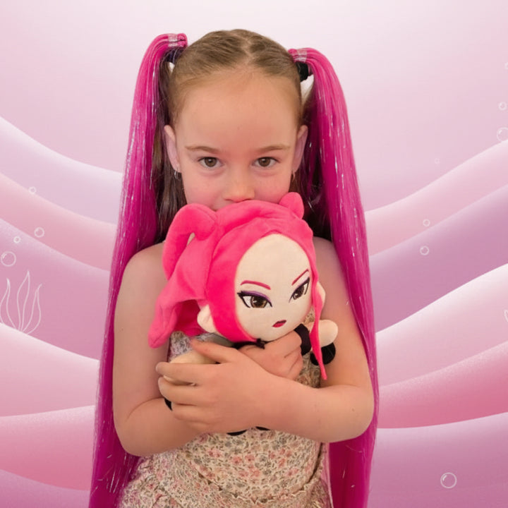 Young girl with pink hair extensions holding a plush toy against a pink background