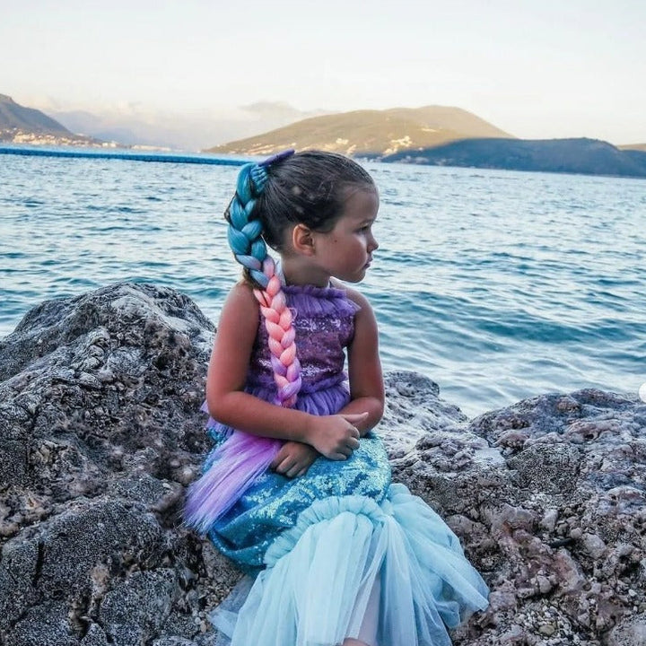 Kid posing as a mermaid wearing Mermaid Hair Extensions