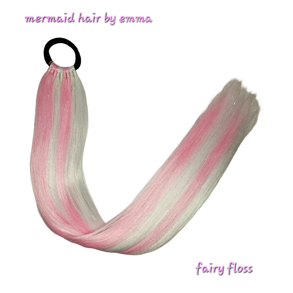 A set of pink and white mermaid hair extensions with elastic for tying into hair.