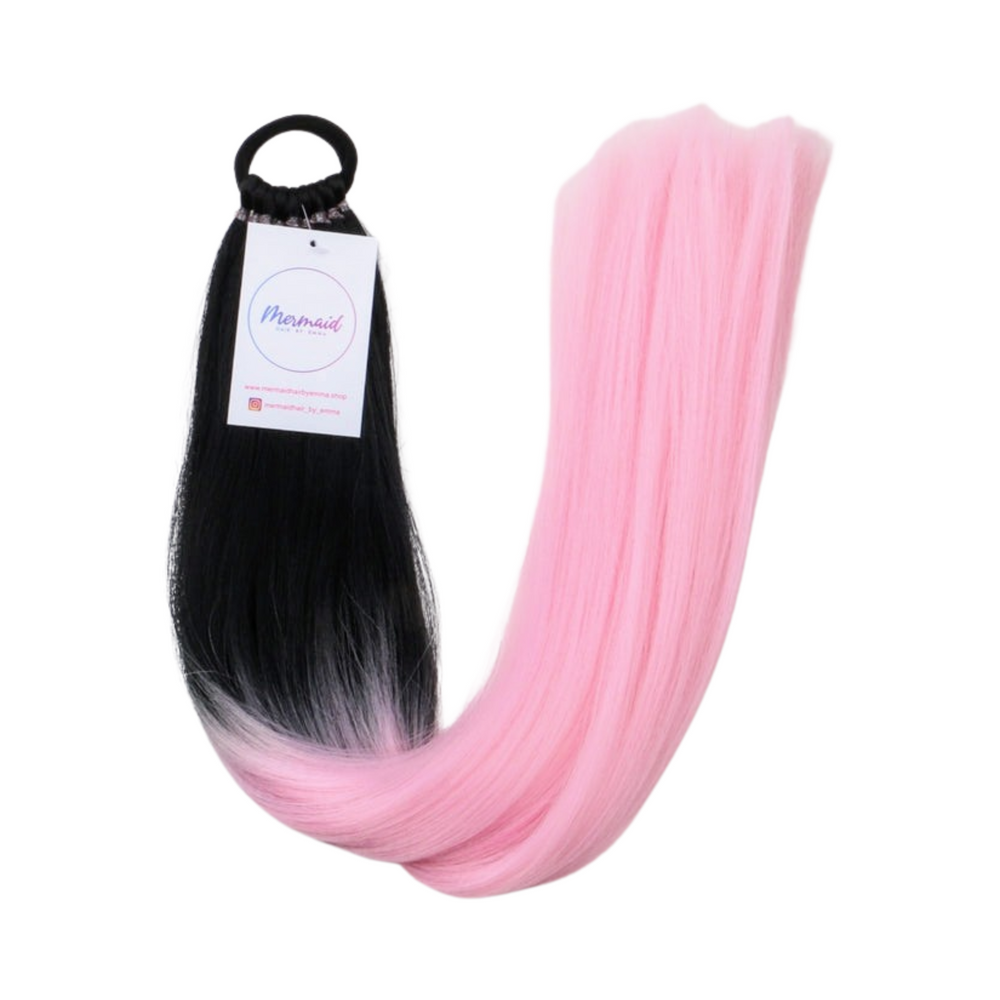 A set of mermaid-style hair extensions with a gradient of black to pink color, tied together at one end with a label attached that reads 'Magic'.
